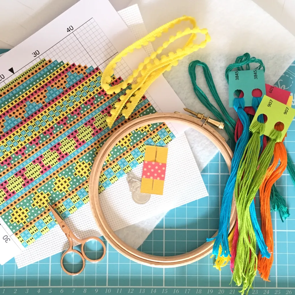 tools for cross-stitch: needle, cloth, threads